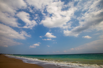 sandy ocean shore, sky and clouds