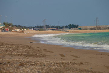sandy ocean shore, sky and clouds