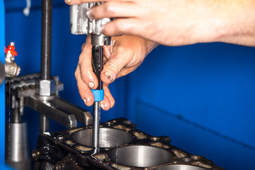 Car engine repair at the factory and parts after disassembly.