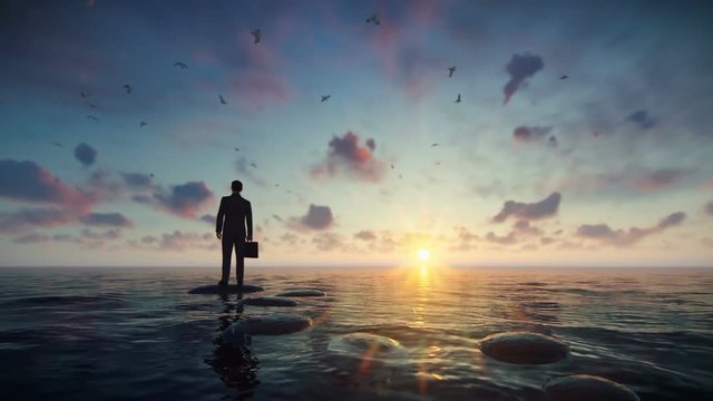 Businessman with briefcase standing on a pebble on a lake surrounded by seagulls against beautiful sunrise