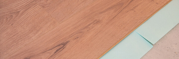 instaling floor laminate flooring with texture hardwood, top view.