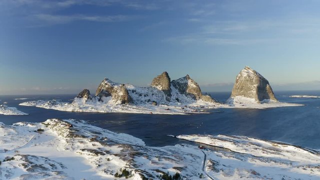 Winter in Tr&aelig;na, iconic mountains of Sanna island, salmon farm, Nordland, Northern Norway, aerial drone shot