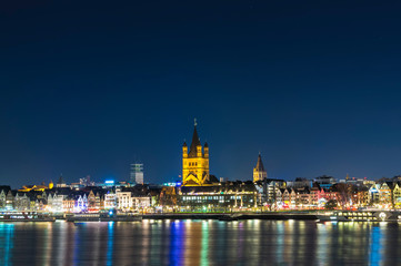 River Rhine with illuminated Cologne Old Town and church of Gross St. Martin