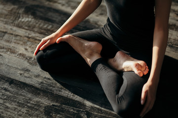 asian young woman sitting in Lotos pose. Businesswoman practicing meditation in yoga hall after...