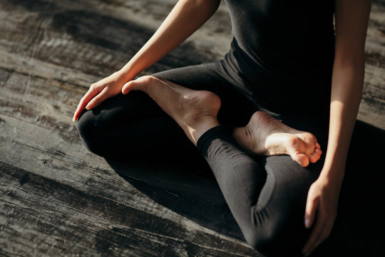 asian young woman sitting in Lotos pose. Businesswoman practicing meditation in yoga hall after finish working. Time for Yoga and relaxation