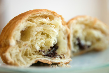 Broken in half croissant with chocolate closeup