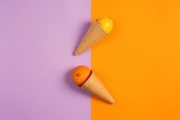 Ice cream with natural orange and lemon fruits. Concept of genuine and biologic fruit. Purple and yellow background