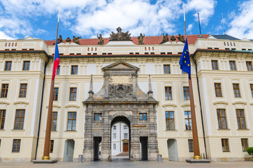 Fototapeta premium Matthias Gate of New Royal Palace (Novy kralovsky palac) and EU and Czech flags at flagpole in Prague Castle Hradcany, Lesser Town Mala Strana district, Bohemia, Czech Republic