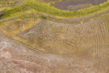 Aerial view of unusual markings in the ground near a water reservoir
