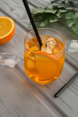 Aperol spritz cocktail in glass on the grey wooden background.  Location vertical. Copy space.