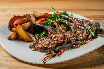 Grilled ribs cooked with vegetables and rosemary.