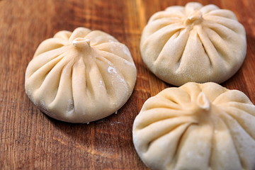 khinkali raw on a wooden board