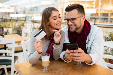 A young couple browsing through an online store.