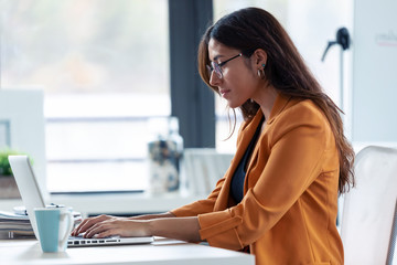 Business young woman working with laptop in the office.