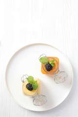 BlackBerry berry with honey on a white plate. Photo on white background. Copy space.