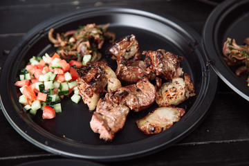 Barbecue meat with onions and tomatoes.