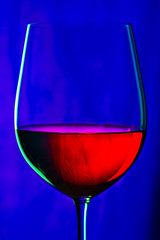 Glass of red wine on dark blue background