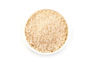 Risotto rice in a bowl, isolated on white background