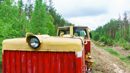 View of a part of narrow gauge railway locomotive on forest background. Extraction and transportations of peat.
