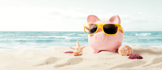 Piggy bank on vacation. Finance and travel concept - obrazy, fototapety, plakaty