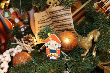 Christmas texture of different sharpness with green artificial spruce branches with Christmas toys...