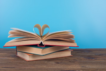 An open book, pages folded in the shape of a heart, the concept of love to read, education, study. Creative idea