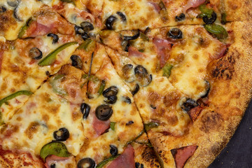 Traditional Italian pizza on a dark background. Top view. Rustic style.