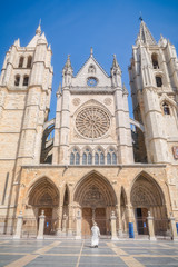 Fototapeta na wymiar A priest visiting the gothic Cathedral of Leon, Castilla Leon, Spain