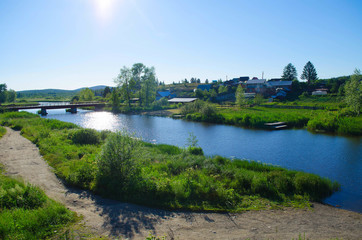 blue river in village and forest under Sunny sky