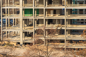 Construction of a multi-storey building. Unfinished large building.
