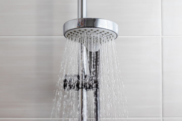 Water flows from the shower head in the bathroom