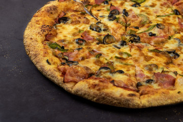 Traditional Italian pizza on a dark background. Rustic style.