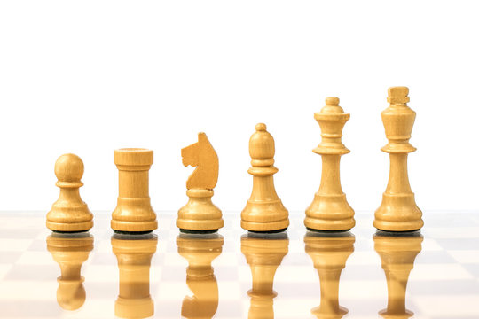 White chess pieces on a chessboard in ascending order. Career growth concept
