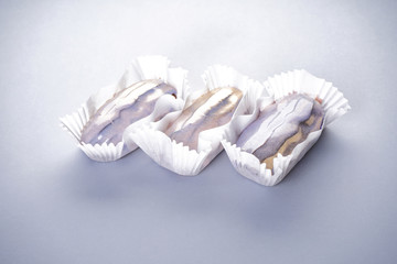 Three eclairs on a gray background close-up. French dessert.