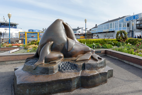 San Francisco, California, USA - April 2, 2018: Sea Lion statue at pier 39 in San Francisco, California. Guardians of the Gate is a bronze sculpture depicting a family of sea lions by Miles Metzger.