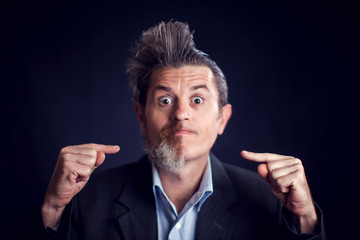 Half bearded man wearing suit in front of black background. People and skin care concept