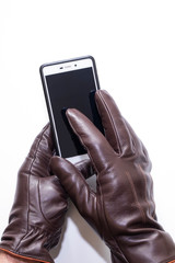 Touch leather gloves and smartphone. White background, isolated
