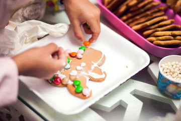 Children doing christmas decoration with hand made cookies