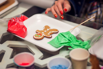 Children doing christmas decoration with hand made cookies