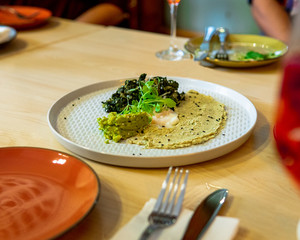 group of friends sitting at the table ready to share a delicious gourmet dish