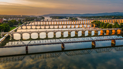 Many bridges over river in sunset, Harrisburg, Pennsylvania, Susquehanna river crossings aerial...