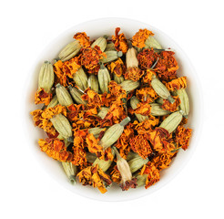 Dry marigolds in a white bowl. Isolated picture.
