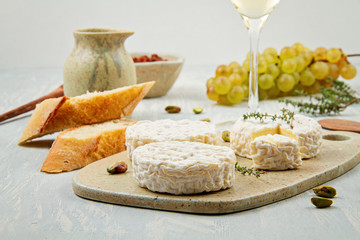 French cheese plate and a glass of wine for buffet party. Traditional french and italian entires