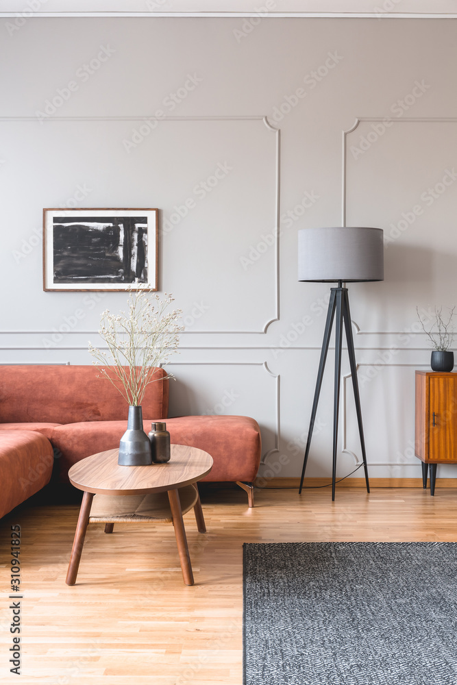 Poster stylish tall grey lamp in elegant living room interior with comfortable brown corner sofa