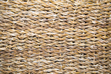 Background braided algae hyacinth yellow-brown with a beautiful weave in the form of braids. Backgrounds, design, structures.