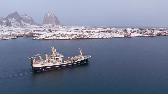 Fishing vessel in winter, Tr&aelig;na archipelago, Nordland, Northern Norway, aerial drone shot