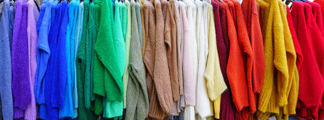 Colorful hanging display of wool sweaters