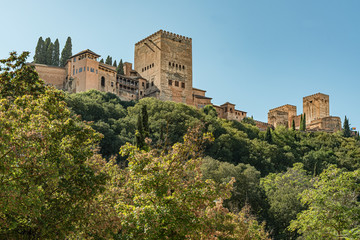 Fototapeta na wymiar View of the famous palace of Alhambra in Granada, Spain. Low angle view of the majestic palace and fortress