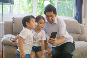 Grandfather and grandson with headphones listen to music