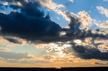 sun through clouds at sunset